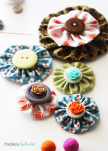 Fabric yo-yo's are a great way to use fabric scraps! Free templates with tutorial at Positively Splendid.