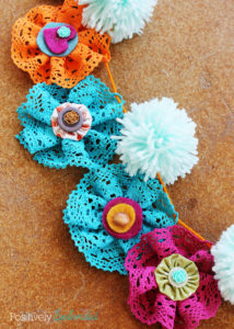 Lace flower and pom pom garland. So pretty and fun!