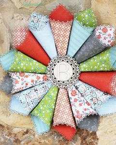 This rolled paper wreath is so pretty, and such a great way to use pretty patterned papers!
