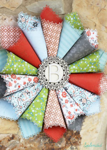 This rolled paper wreath is so pretty, and such a great way to use pretty patterned papers!