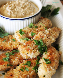 Crispy oven-friend chicken dippers with pesto-yogurt dip.