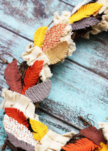 Fall feather wreath made with paper embellishments from the scrapbooking aisle. Easy and fun!