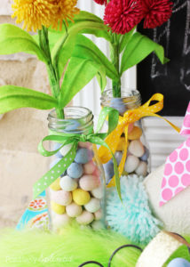Fill a simple milk bottle with candy for a super easy Easter centerpiece. #HersheysEaster