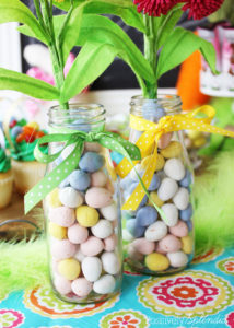 Fill a simple milk bottle with candy for a super easy Easter centerpiece. #HersheysEaster