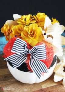 DIY Pumpkin Centerpiece - Made with pretty wood flowers and an artificial pumpkin from Michaels #makeitwithmichaels #michaelsmakers