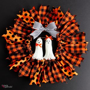 Halloween Ribbon Wreath -- So easy to make with an embroidery hoop, and these ghost tassel embellishments are adorable!